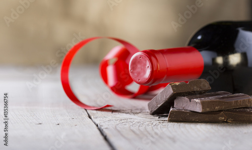 chocolate and bottle of red vine with red ribbon .valentines day