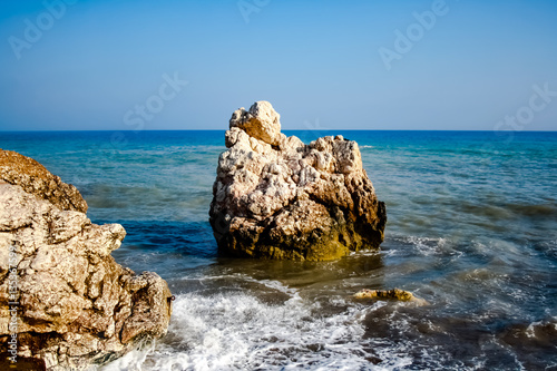 A stone in the sea, where the waves break on the beach near the rock of Aphrodite./Stone on the beach./ Petra tou Romiu.Cyprus  beach photo