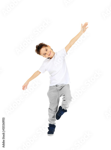 Cute boy dancing on white background