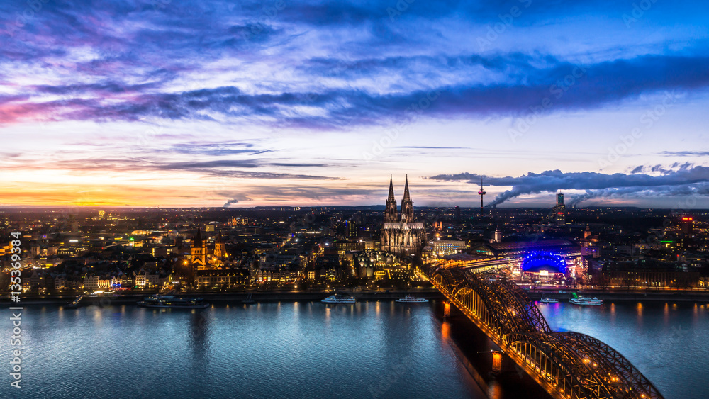Beautiful sunset above Cologne. Aerial view of the Cathedral - Dom and Hohenzollern bridge