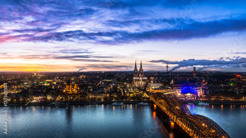 Beautiful sunset above Cologne. Aerial view of the Cathedral - Dom and Hohenzollern bridge © Puravidaniel