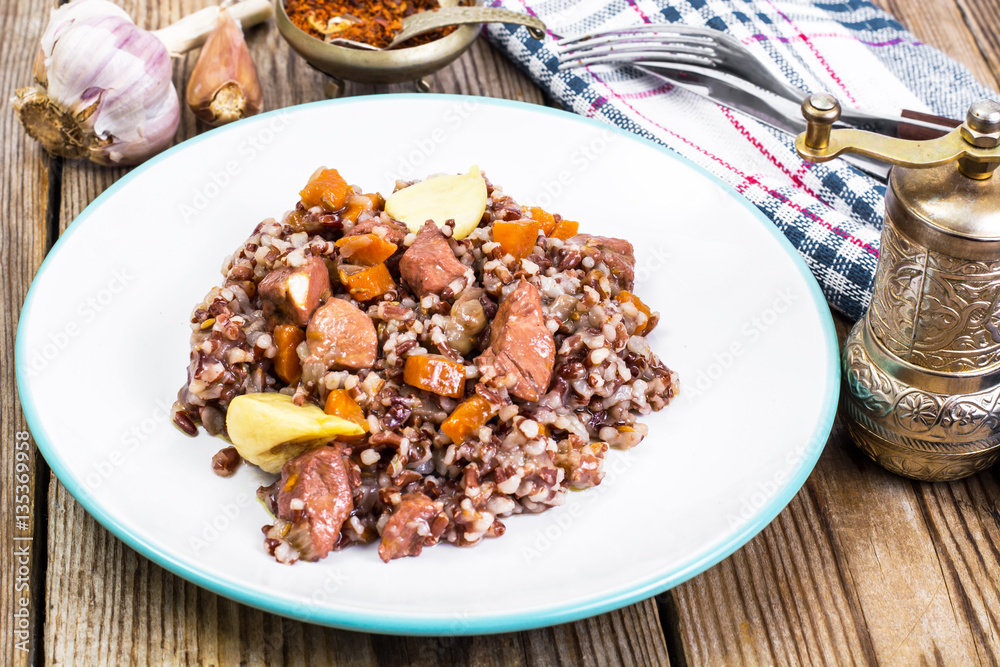 Pilaf with red rice with chunks of beef, carrots and garlic Pilaf with red rice with chunks of beef, carrots and garlic