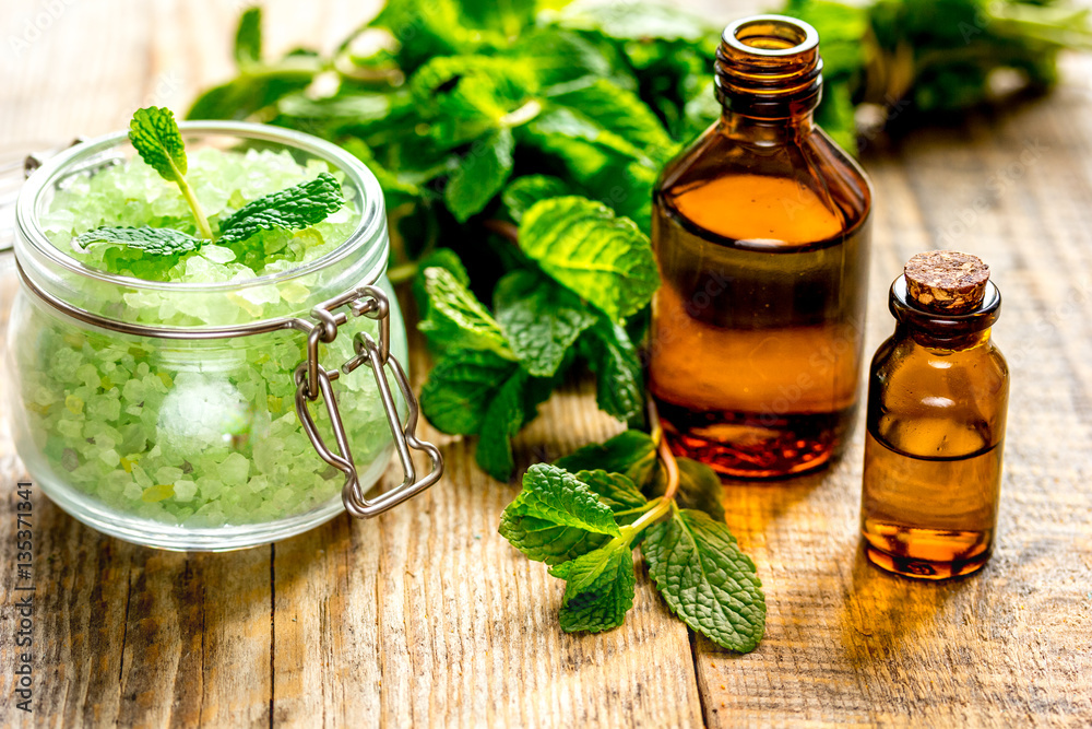 organic cosmetics with herbal extracts of mint on wooden background organic cosmetics with herbal extracts of mint on wooden background