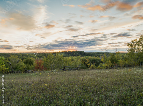 Fototapeta Naklejka Na Ścianę i Meble -  Sunset Over Rural Farm Land