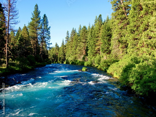 The amazing turquoise waters at Wizard Falls on the Metolius River in Central Oregon glowing with the morning sun. 
