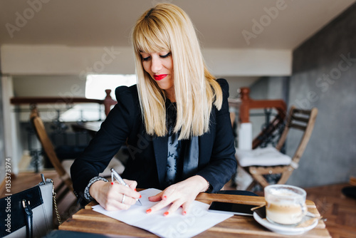 Business woman writing a greeting card letter to a good friend.