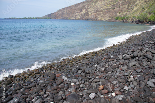 Surf and eroded lava rocks photo