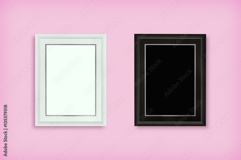 White and black wooden frame on pink wall. White and black wooden frame on pink wall.