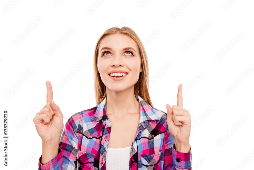 Portrait of smiling happy girl pointing up with fingers Portrait of smiling happy girl pointing up with fingers