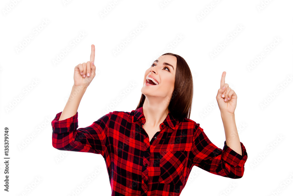 Young happy smiling woman pointing up with fingers Young happy smiling woman pointing up with fingers
