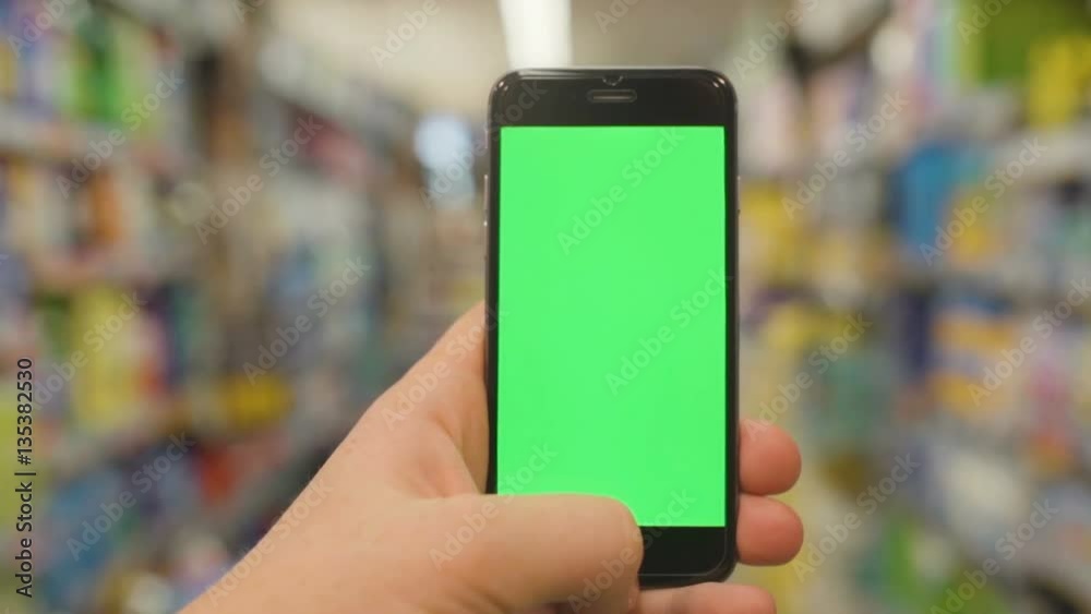 Man at Supermarket Using Smartphone with green vertical screen. Closeup. HD, 1920x1080. Man at Supermarket Using Smartphone with green vertical screen. Closeup. HD, 1920x1080.