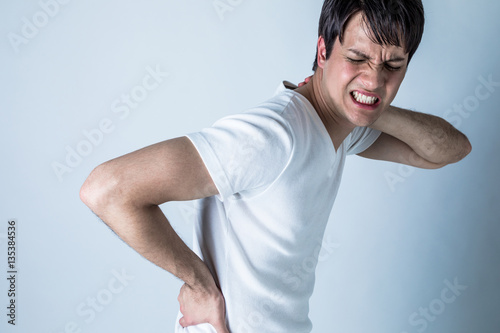 young man having a pain in his neck and low back