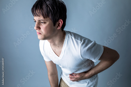 young man having a stomachache photo