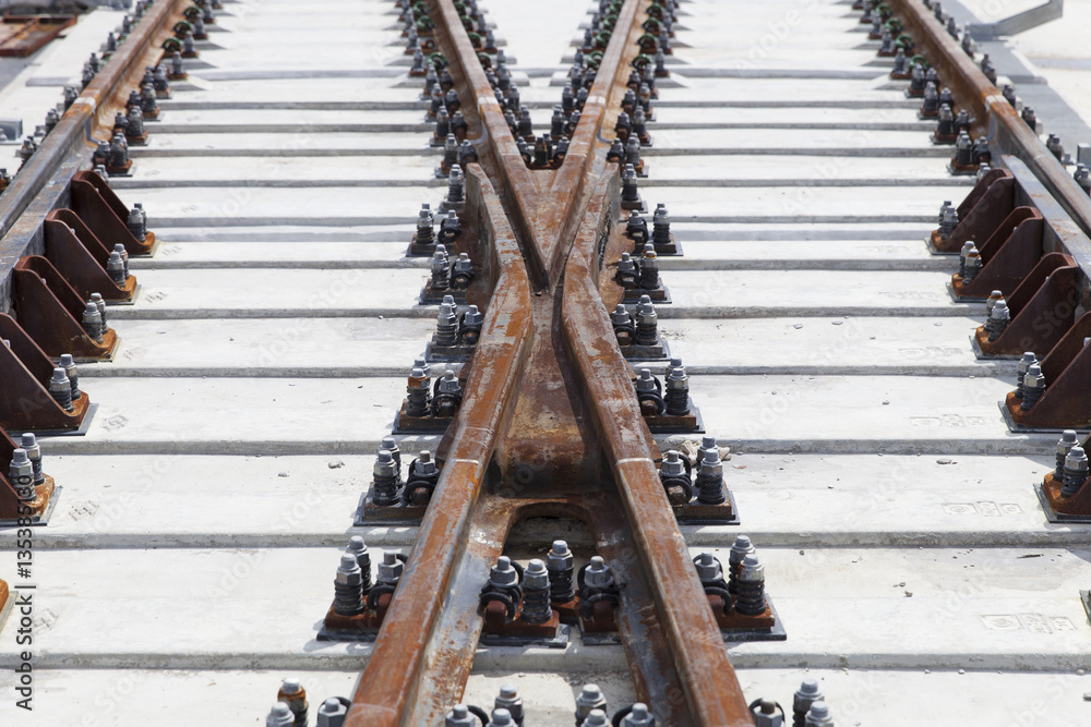 Fototapeta premium metal rail of rapid electric train transit on concrete railway sleepers