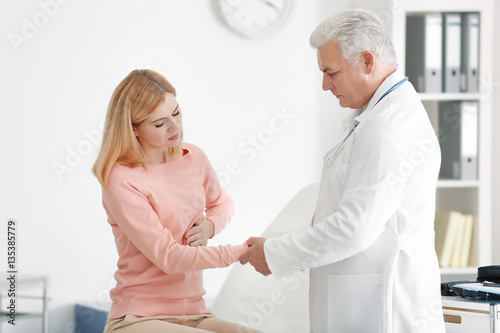 Doctor measuring pulse of p...