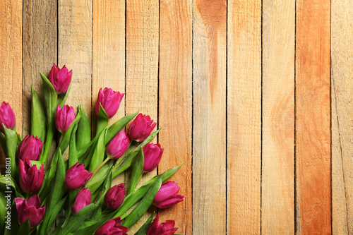 Pink beautiful tulips on wooden background