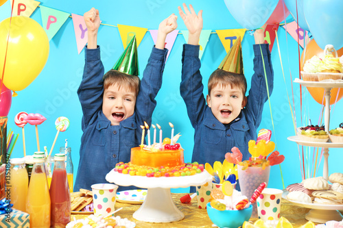 Cute little twins celebrating birthday at home