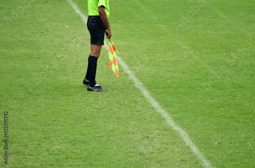 Assistant soccer referee running along side line