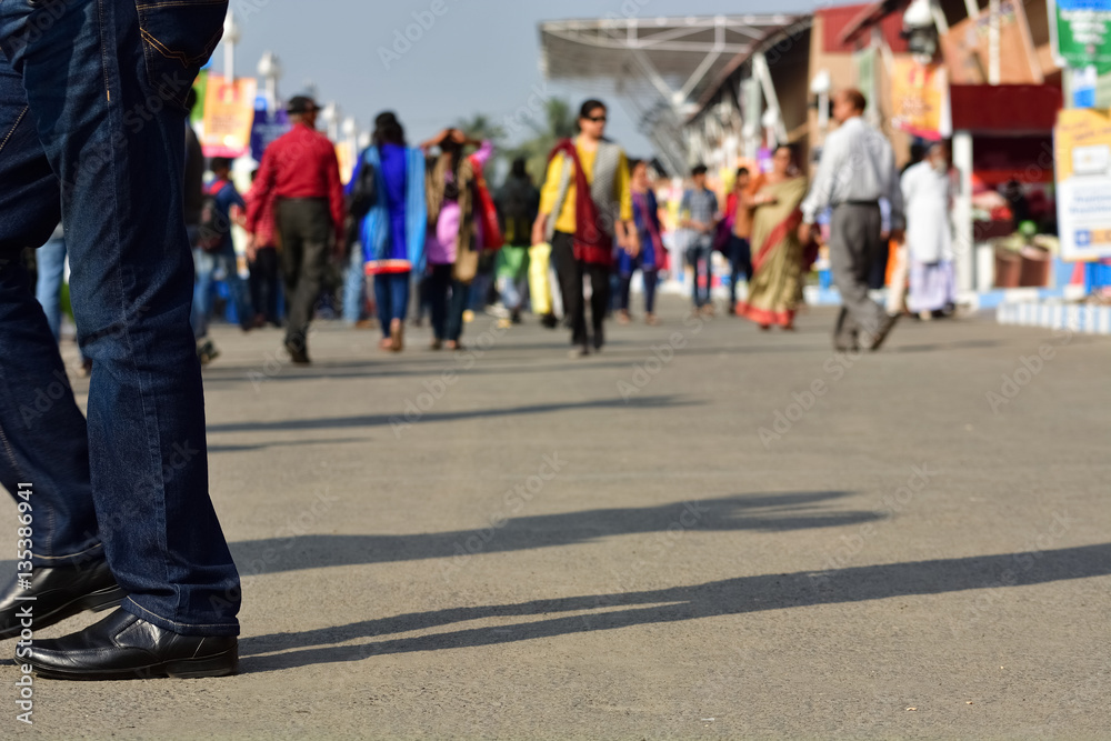 Motion blurred pedestrians are walking