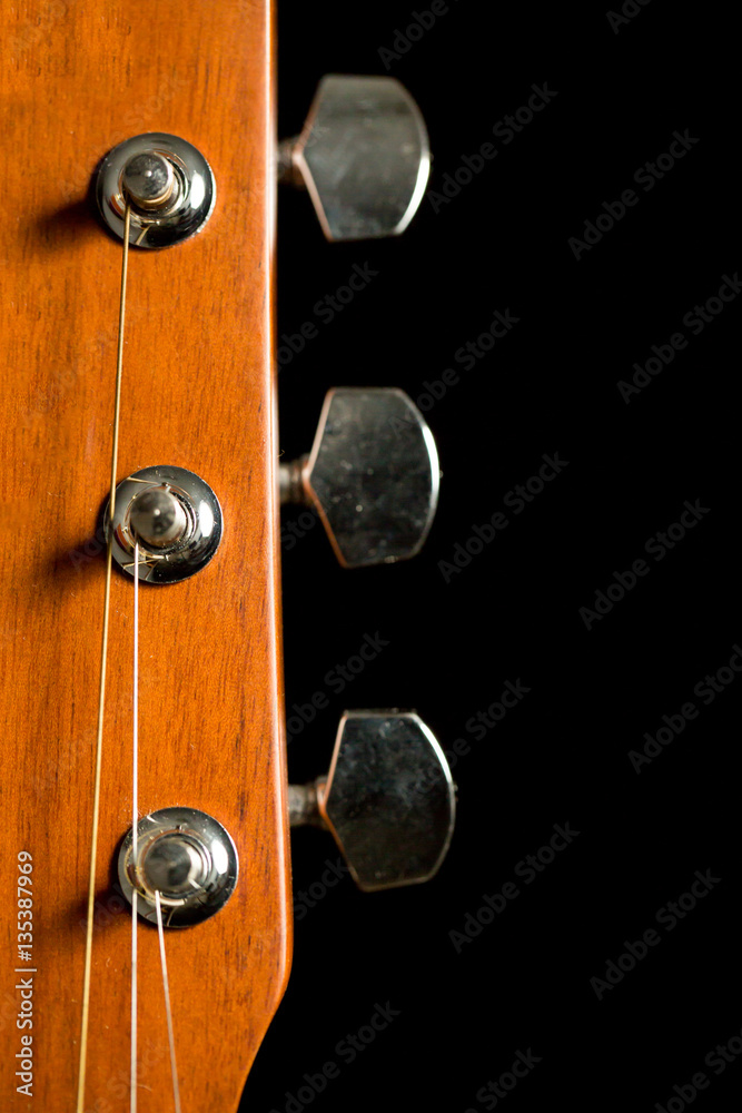 head of acoustic guitar on black background head of acoustic guitar on black background