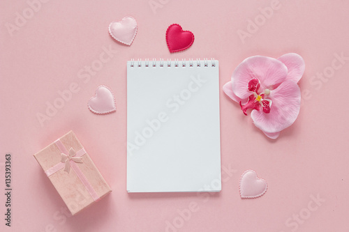 Open blank notebook with gift box, orchid flower and hearts on a © WindyNight