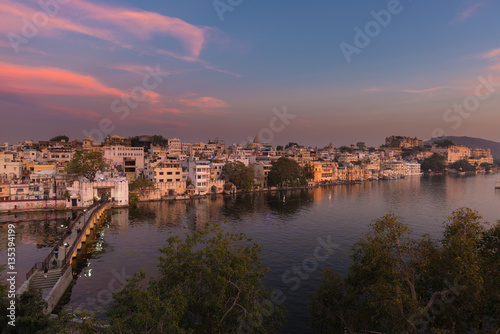 Udaipur cityscape with colorful sky at sunset. The majestic city palace on Lake Pichola  travel destination in Rajasthan  India
