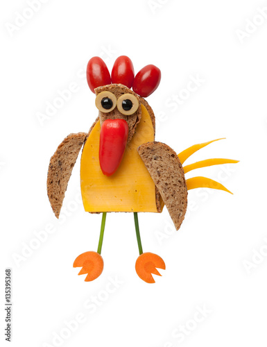 Funny cock made of bread, cheese and vegetables on isolated background