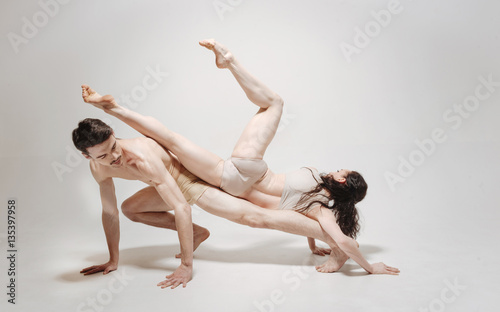 Athletic dancers posing against white background