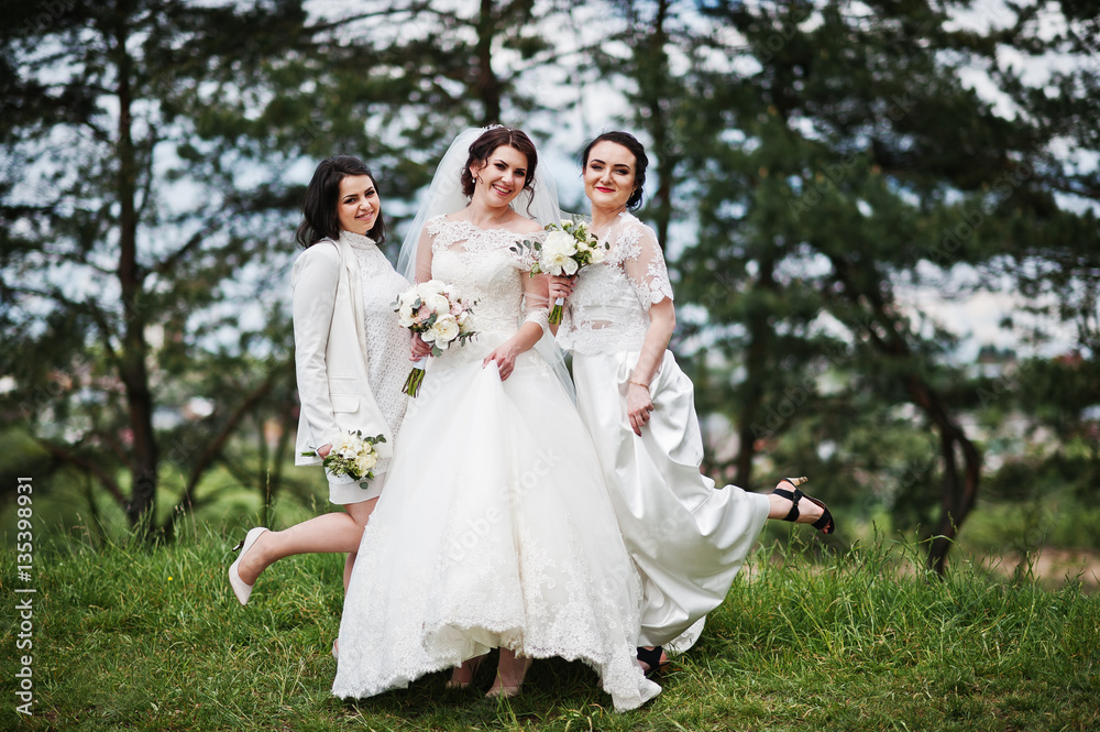 Pretty bride with bridesmaids on white dresses with bouquets on Pretty bride with bridesmaids on white dresses with bouquets on