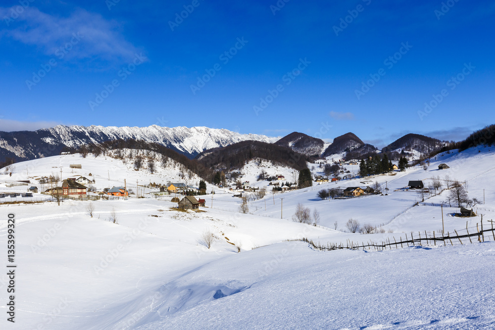 winter landscape with a mountain village in Romania