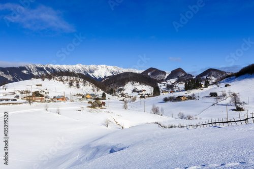 winter landscape with a mountain village in Romania © czamfir