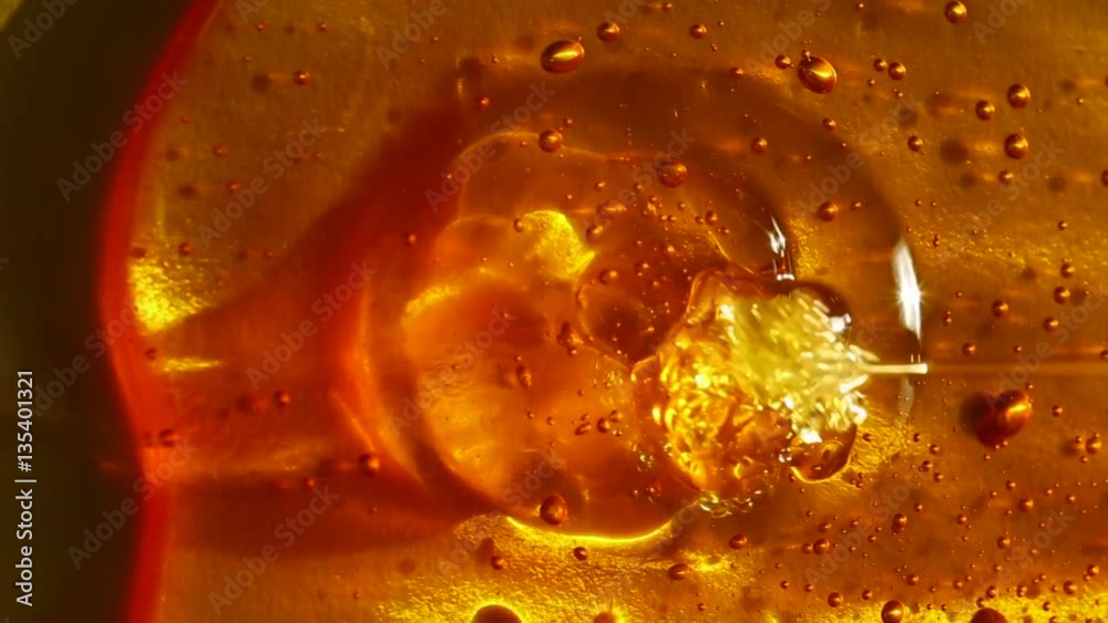 honey texture with bubbles on a gold background