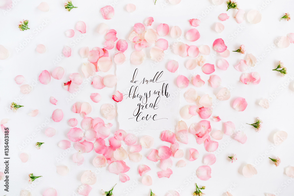 Do small things with great love. Inspirational quote made with calligraphy and floral pattern with pink rose petals. Flat lay, top view