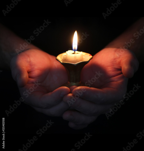 burning candle in a hand