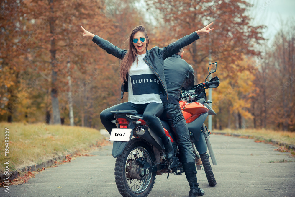 Couple with motorbike Stock Photo - Alamy