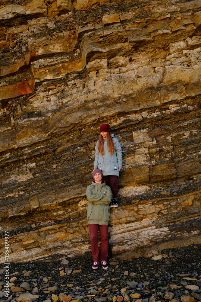 Young couple posing on a background of cliff