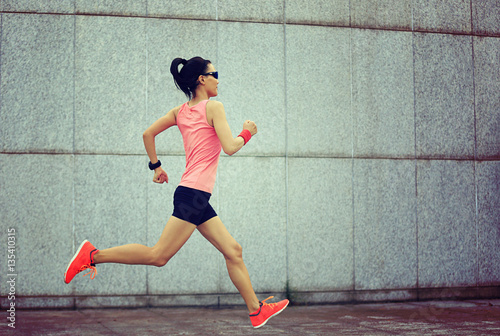 young fitness sport woman running on city