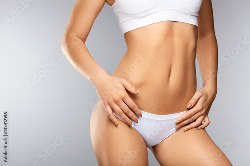 Woman Slim Body. Сloseup Of Beautiful Female In Shape In Bikini © puhhha
