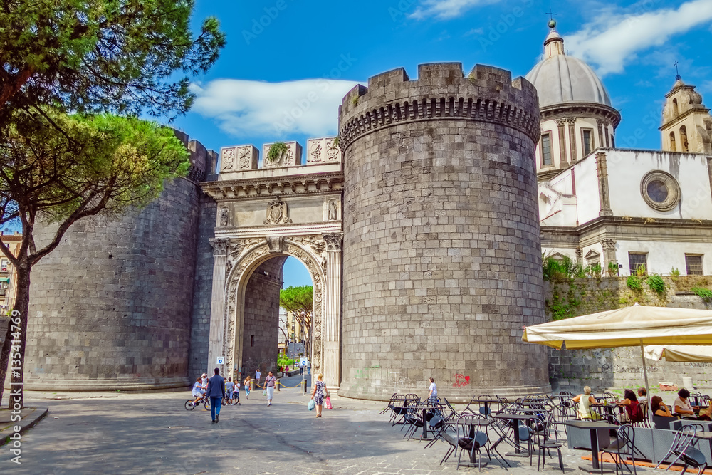 NAPLES, ITALY - AUGUST 7, 2016: The east side of the ancient city gate Porta Capuana. The gate gives name to the zone, which is one of the ten boroughs of Naples and part of the Fourth Municipality.