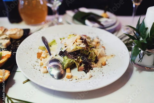 Caesar salad served on white plate