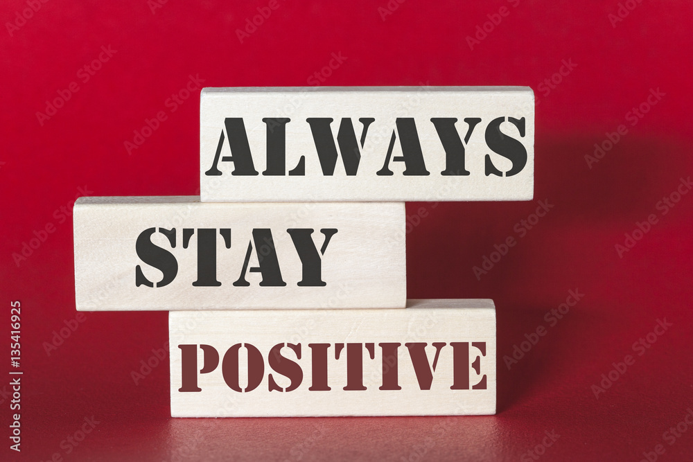 Always stay positive. Motivational quote written on wooden tiles