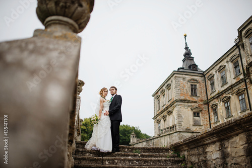 Loving wedding couple at their happy wedding day background old