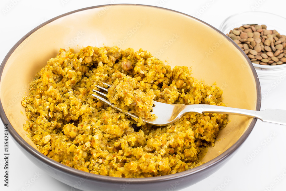 Lentil porridge with butter in a ceramic bowl on a white backgro Lentil porridge with butter in a ceramic bowl on a white backgro
