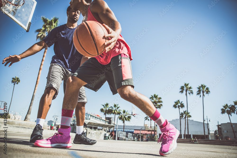 Fototapeta premium Two basketball players playing outdoor in LA