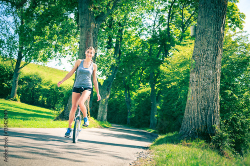 Young Woman Riding Her Unicycle photo