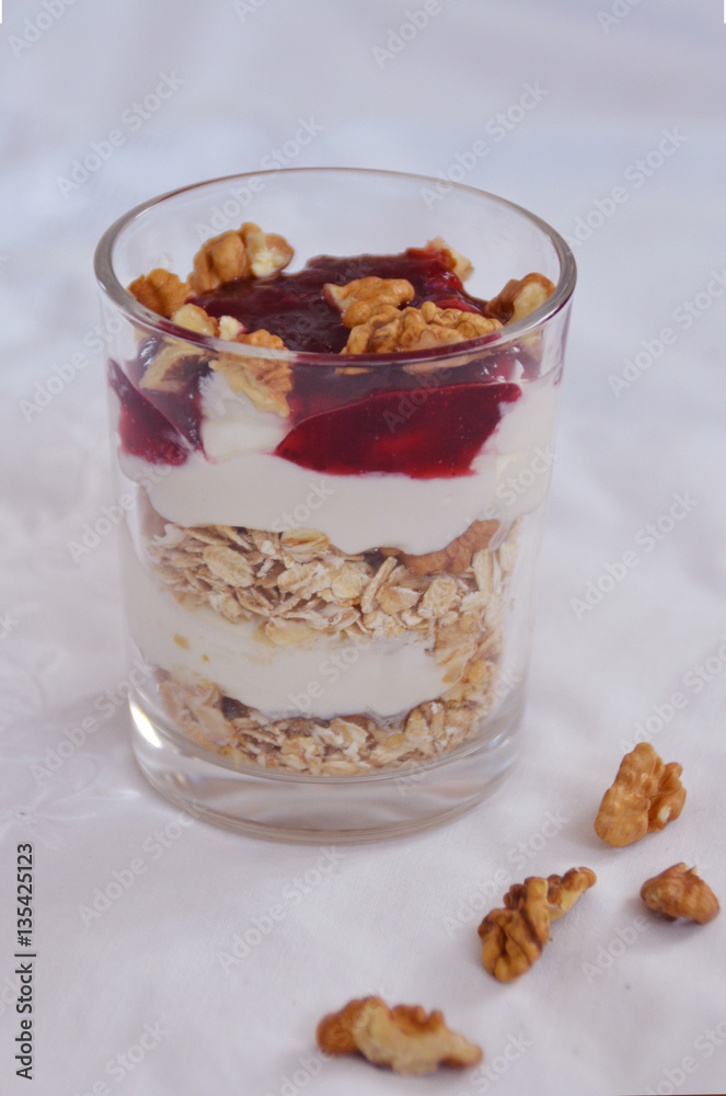 yogurt with muesli and jam on a white surface yogurt with muesli and jam on a white surface