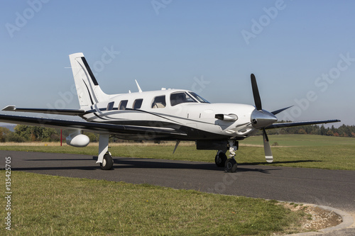 Private small single turboprop aircraft on airport runway