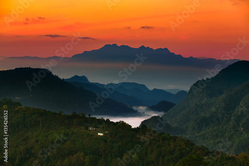 Misty morning with sunrise over forest mountain,Beautiful landscape at Doi Ang Khang,Chiang Mai,Thailand.