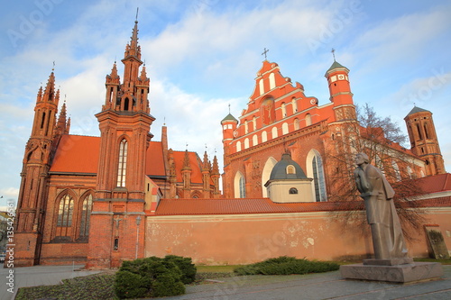 VILNIUS, LITHUANIA: St Anne's Church and Bernardine Church with Adam Mickiewicz statue on the right hand side