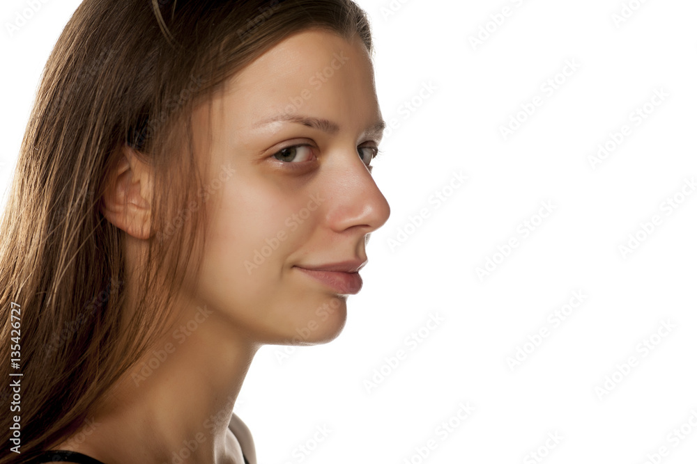 profile of young woman without makeup on white background profile of young woman without makeup on white background